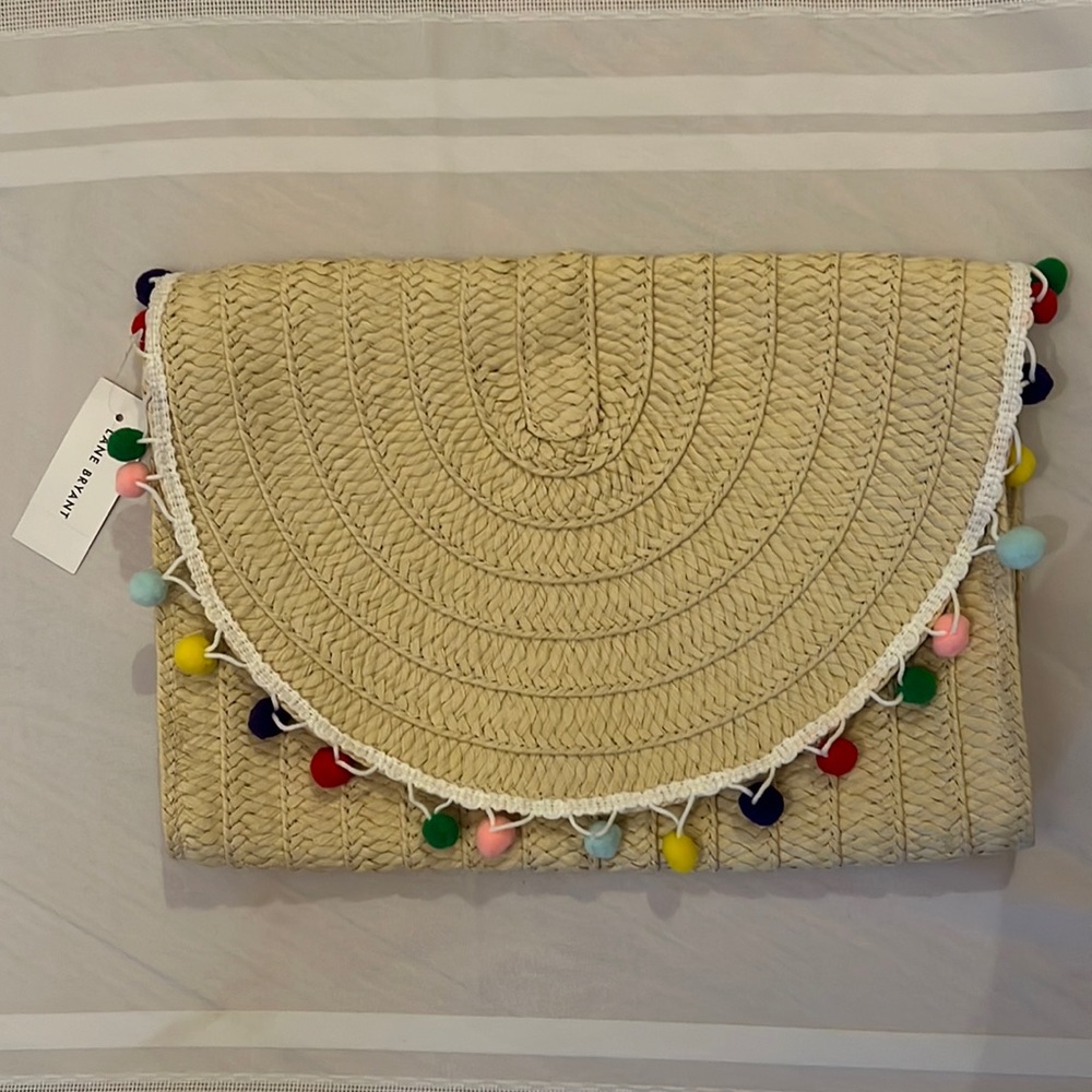 Straw purse with pom poms